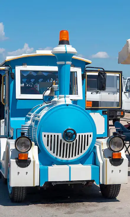 Blue and white train for tours in Nafplio parked in the harbour