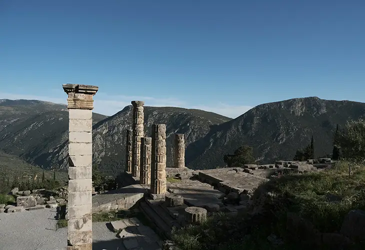 Ruins of the ancient oracle of Delphi with a breathtaking view of the mountains in the back