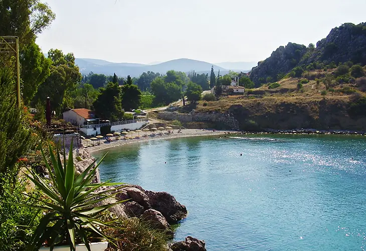 Ancient Asini beach, a small pebble beach with a taverna above it