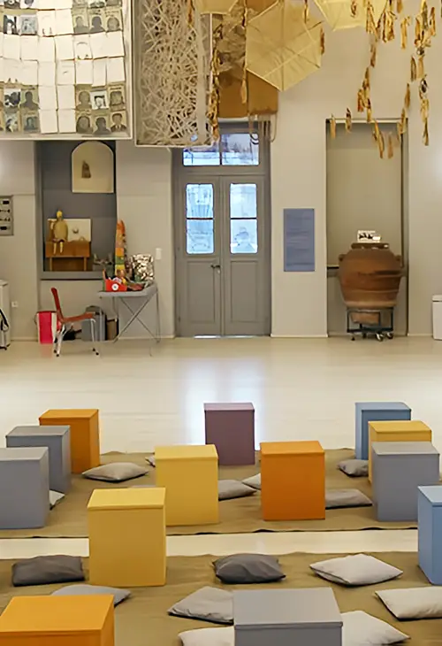 Pillows on the floor and stools in the centre of the Childhood Museum of Nafplio
